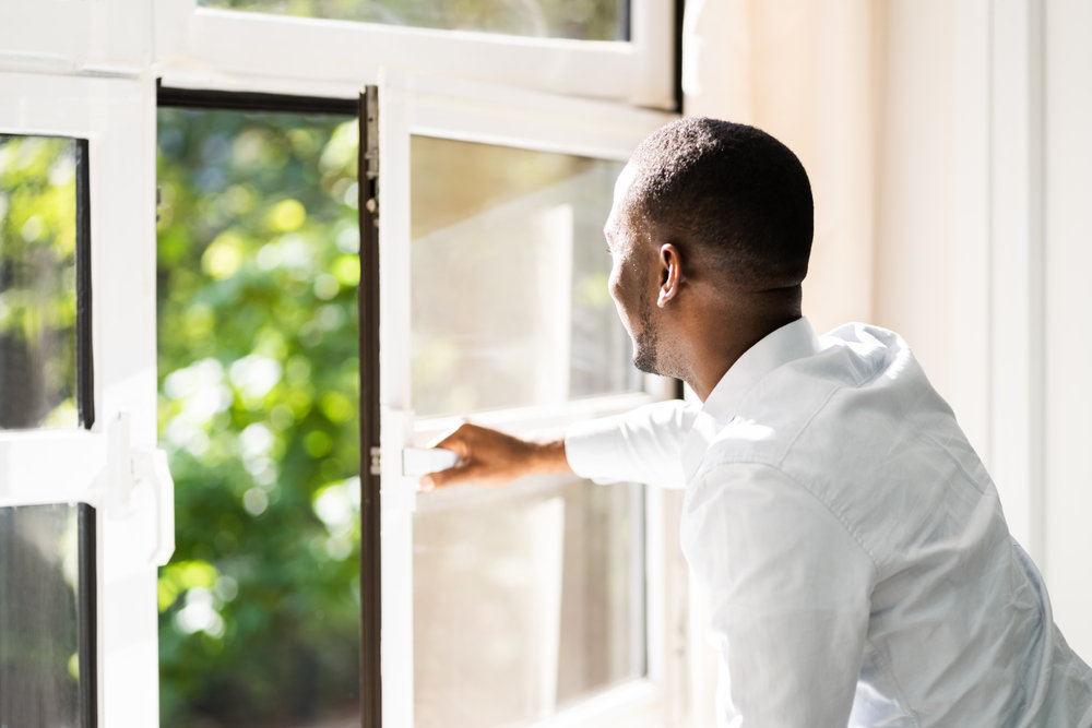 Man opening window - Signs that It Is Time to Replace Your Windows